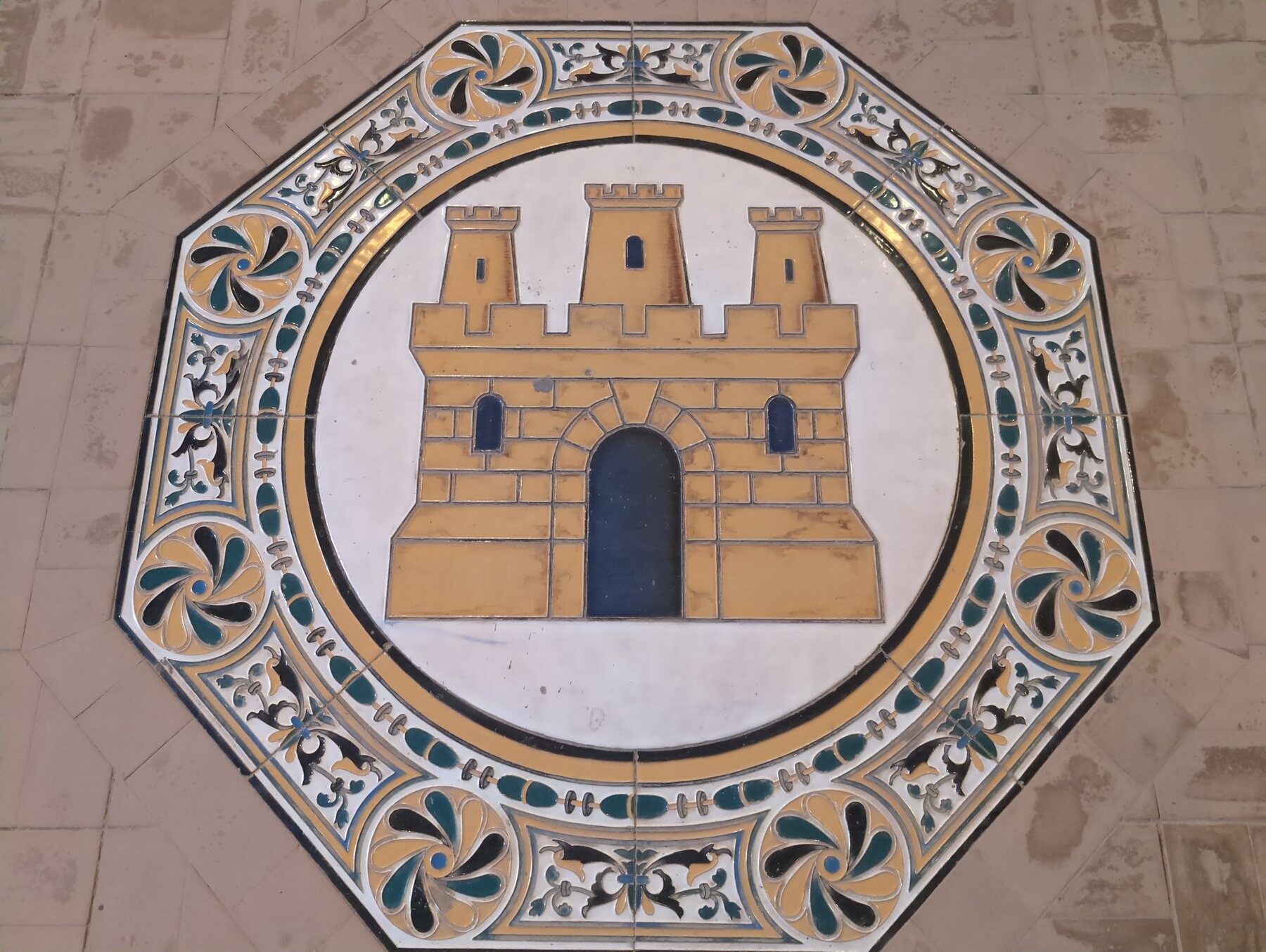 A large ceramic castle medallion at Plaza de España