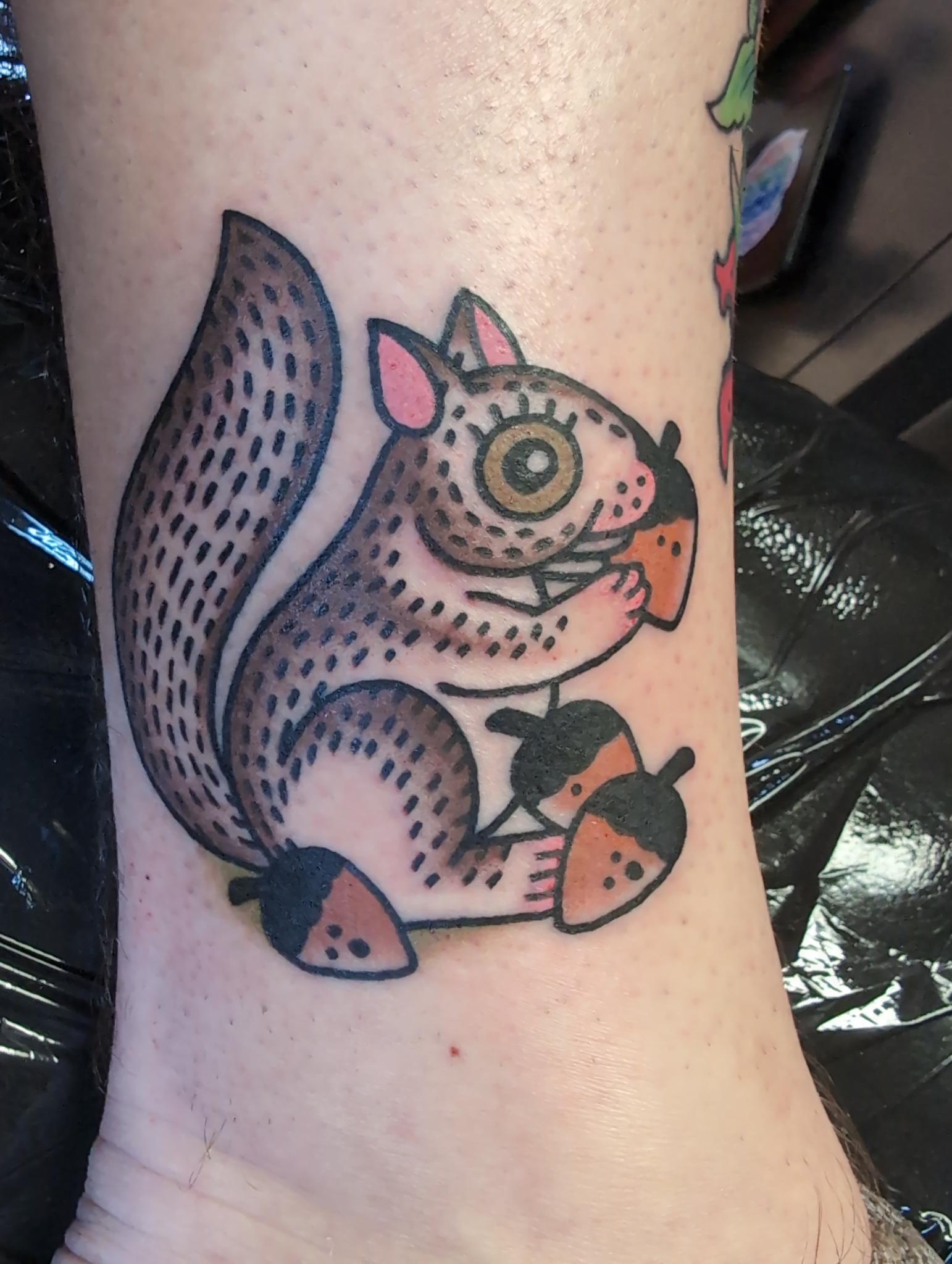 Squirrel grabbing nuts, blackwork tattoo